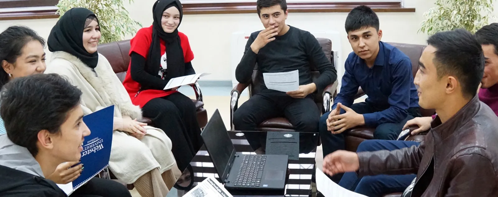 Group of students sitting together talking.