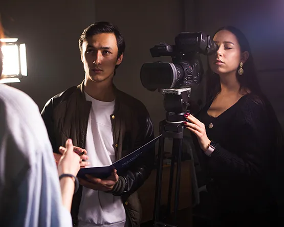 Students practicing shooting interviews on video.