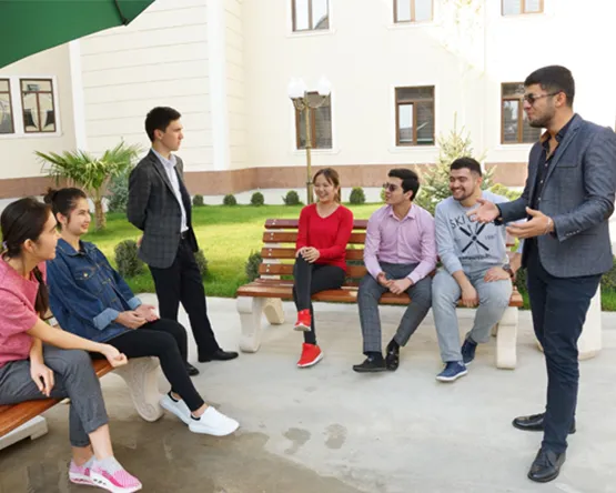 Students gather and talk outside on patio