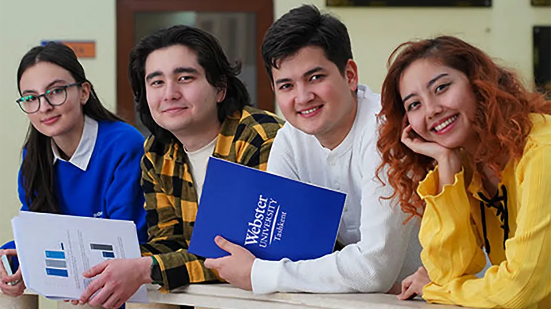 Students standing in a line and smiling